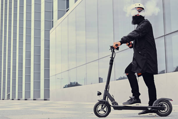istock A man vaping and riding by electric scooter. 1010241156