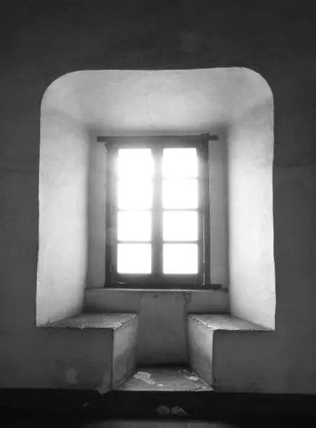 Beanch window of an old monastery in Queretaro, México with sunlight entering. Black and white.
