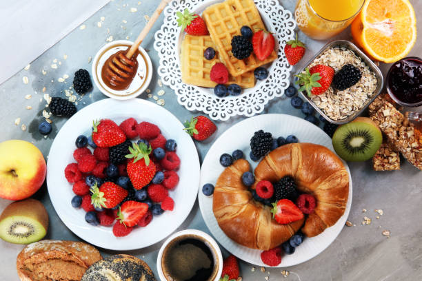 istock breakfast on table with waffles, croissants, coffe and juice. 1010243910