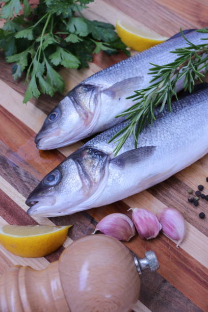 istock Raw Sea bass fish with herbs and spices 1010245128