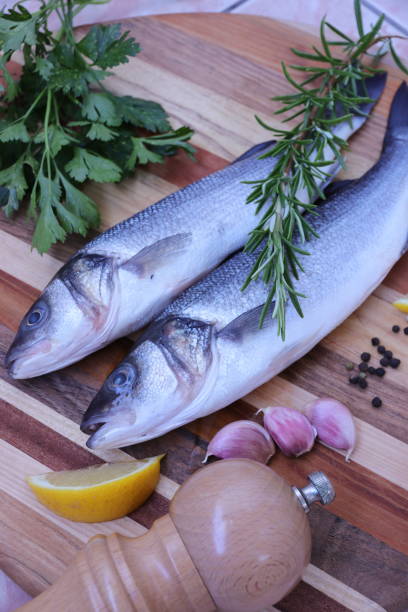 istock Raw Sea bass fish with herbs and spices 1010245148