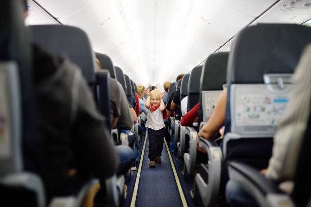 istock Happy little boy during traveling by an airplane 1010245156