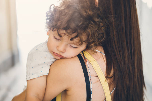istock Toddler Sleeping On His Mother's Shoulder 1010250110