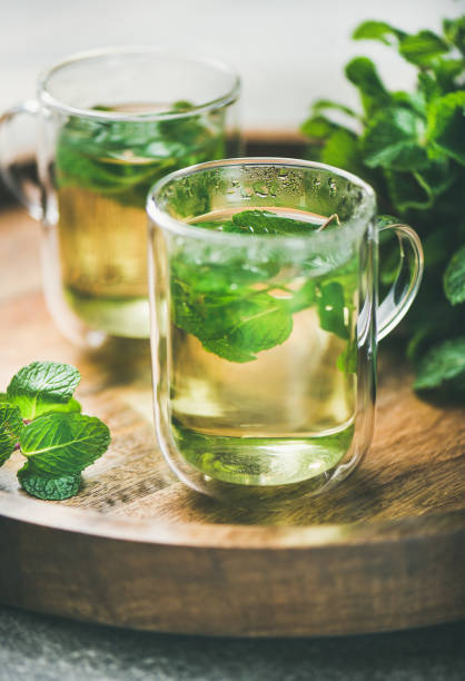 Hot herbal mint tea drink in glass mugs stock photo