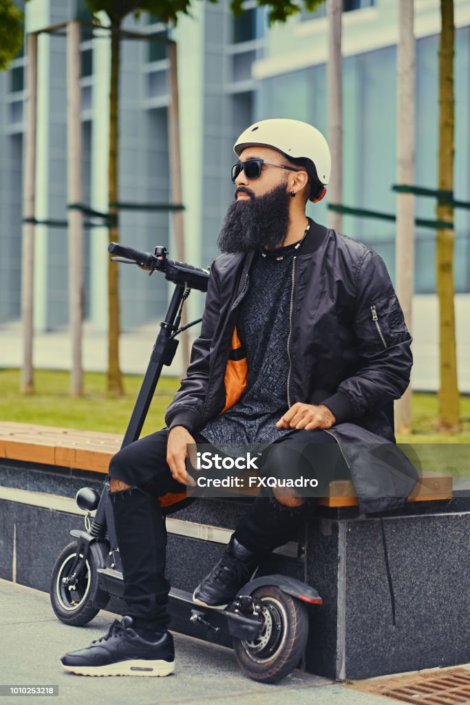 A Man Relaxing On A Bench After Riding By Electric Scooter Stock Photo - Download Image Now - iStock A Man Relaxing On A Bench After Riding By Electric Scooter Stock Photo - Download Image Now - iStock