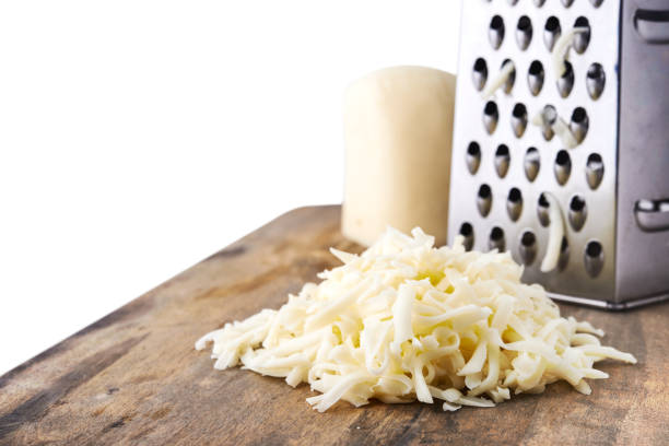 heap of grated mozzarella cheese heap of grated mozzarella cheese for pizza isolated on white background shredded mozzarella stock pictures, royalty-free photos & images