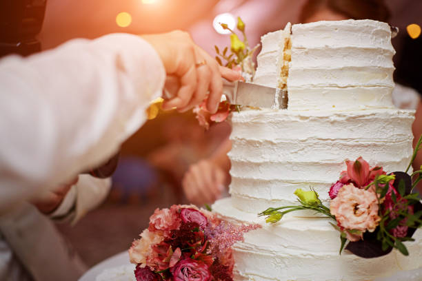 istock Bride and groom are cutting wedding cake 1010255694