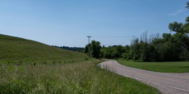 istock Panorama of road curving around hill 1010257892