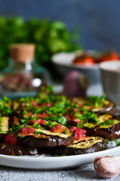 istock Spicy eggplant with tomato sauce and cilantro. Grilled eggplant. 1010270020