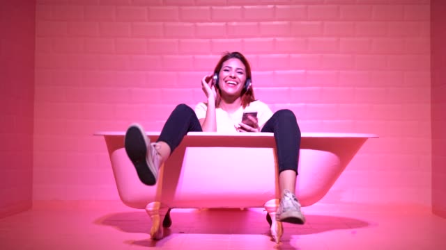 Woman Having Fun in the pink bathtube