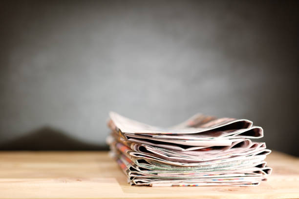 istock Newspaper on wooden table 1010287206