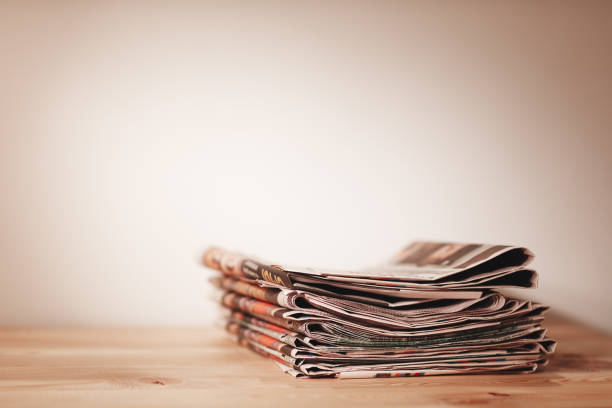 istock Newspaper on wooden table 1010287244