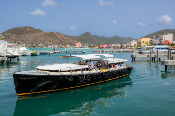 Phillipsburg, St Marteen - July 11, 2018:  A tourist guided boat tour returns in Phillipsburg St. Marteen, a picturesque island country in the Caribbean.