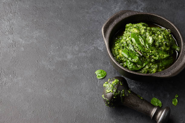 istock Basil pesto sauce in iron mortar, close up view 1010303156