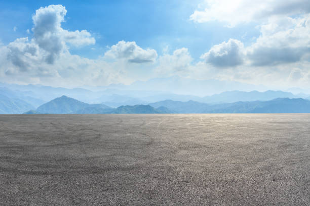 istock Asphalt square and mountain scenery under the blue sky 1010308640