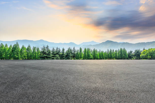 istock Asphalt square and mountain with forest scenery at sunrise 1010308898