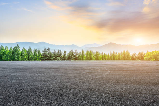 istock Asphalt square and mountain with forest scenery at sunrise 1010308936