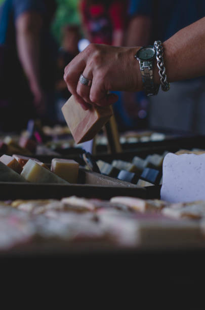 A view of the people searching through the different soap bars at the local farmers market.