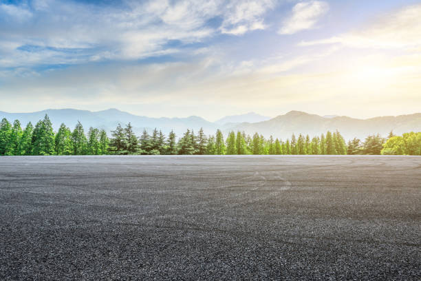 istock Asphalt square and mountain with forest scenery at sunrise 1010309080