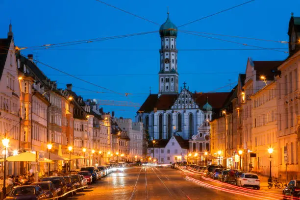 Maximilianstrasse, St. Ulrich and St. Afra Cathedral, Augsburg at dusk, Bavaria, Germany.