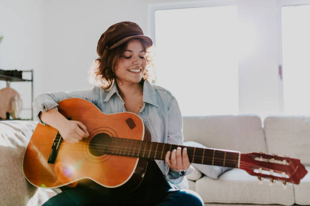 istock Woman playing guitar and enjoying 1010326440
