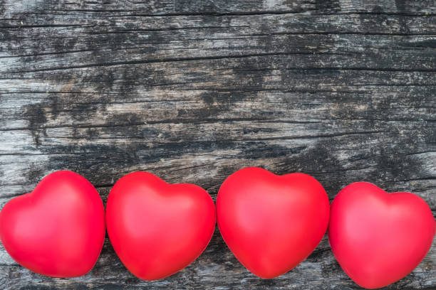 istock Happy Valentines day background idea with red hand on grunge old aged wood backdrop 1010326878
