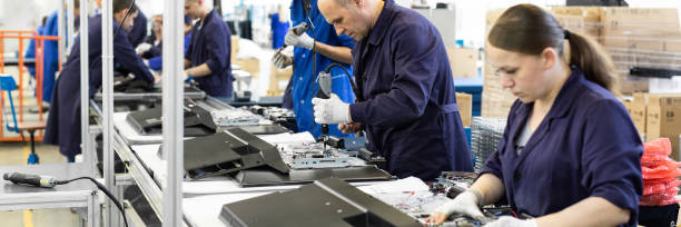 Workshop on assembling telephysics. Testing TVs in the workshop. Electronics assembly line. Minsk, Belarus - May 08, 2018: workshop for assembring televisions tv factory stock pictures, royalty-free photos & images