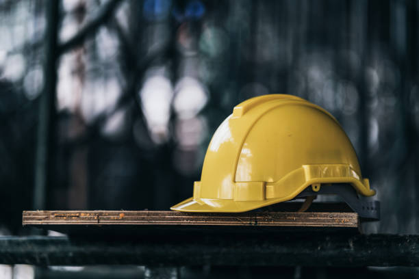 engineer and construction ideas concept with yellow helmet equipment tools at construction site - capacete de obra imagens e fotografias de stock