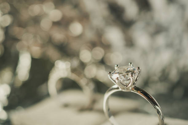 istock luxury engagement Diamond ring with abstract bokeh light background 1010329432