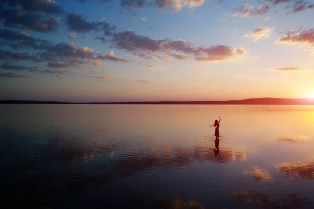 istock Ballerina dancing on the lake at sunset. 1010329514