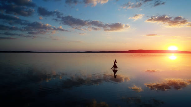 Ballerina dancing on the water with classical dress Salt Lake /Anatolia - Turkey
