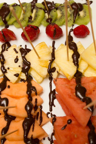 istock slice of various fruits covered with chocolate 1010342988