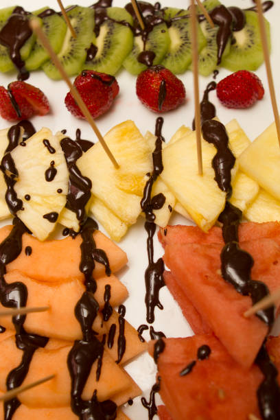 istock slice of various fruits covered with chocolate 1010357326