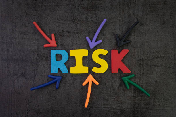 istock Business risk management, result in uncertainty, unpredictable situation concept, colorful arrows pointing to the word RISK at the center of black chalkboard wall, assessment of investment volatility 1010362622