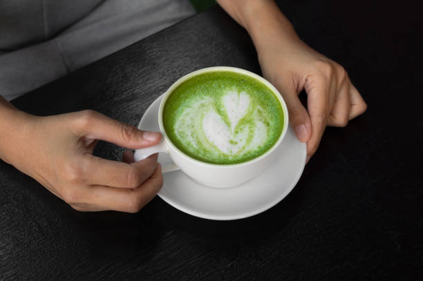 istock Green tea latte in woman hand. 1010366204