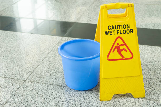 istock cleaning progress caution sign in office, caution wet floor 1010386078