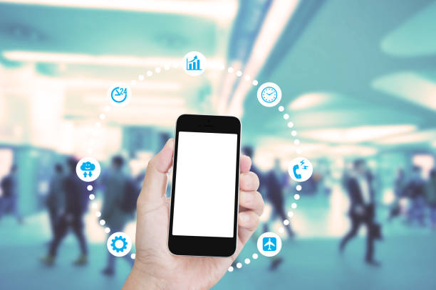 istock Hand holding mobile phone with blurred image of people use for background 1010386488