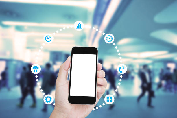 istock Hand holding mobile phone with blurred image of people use for background 1010386540