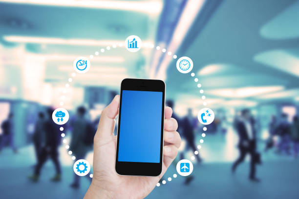 istock Hand holding mobile phone with blurred image of people use for background 1010386628