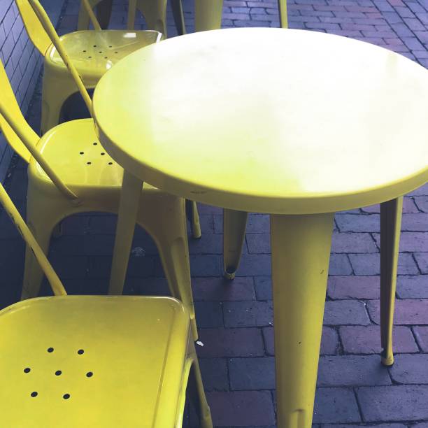 istock Table and Chairs on Bricks at Outdoor Cafe 1010386636