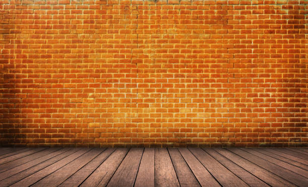 istock Wood floor with red brick wall background 1010389142