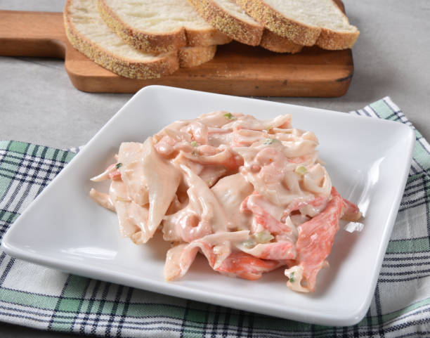 Seafood Salad Dish of seafood salad with crab meat, shrimp and celery with ciabatta bread. seafood salad stock pictures, royalty-free photos & images