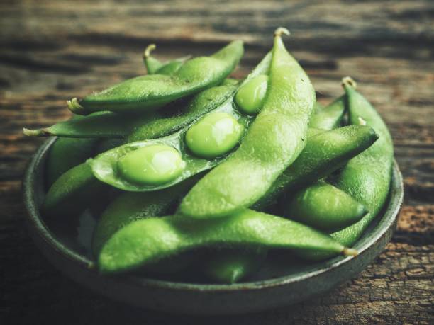 istock Green peas bean on wood background 1010397802