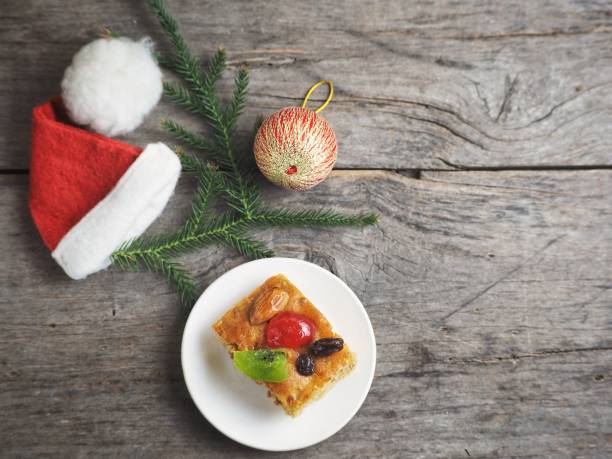 istock Fruits cake and christmas hat 1010397930
