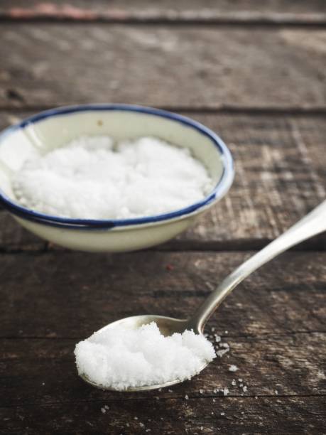 istock Salt on spoon and wood background 1010398266