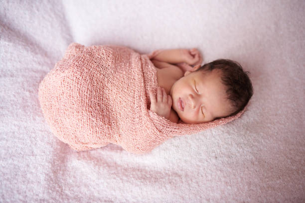 istock Newborn sleep in cloth wrap 1010413156