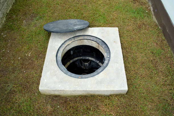 A hole of grease trap with the drain system around the house. stock photo