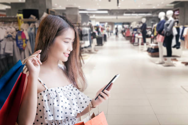 istock Portrait of a beautiful woman using smartphone while shopping 1010425540