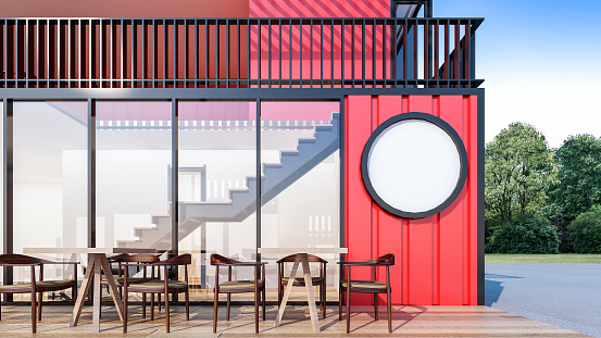 Café and restaurant made from shipping containers , small dining tables are set in outdoor seating with garden view