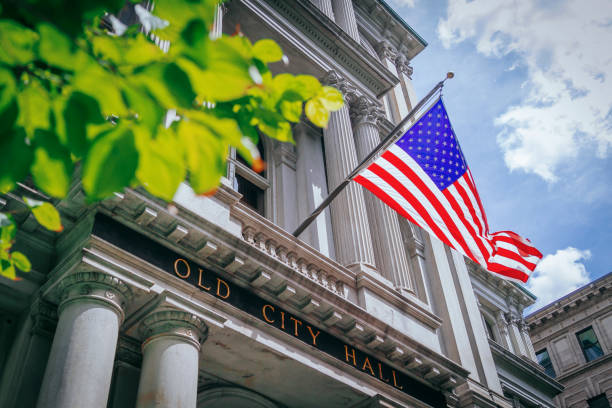 us flag and the old city hall of boston, usa - guildhalls imagens e fotografias de stock